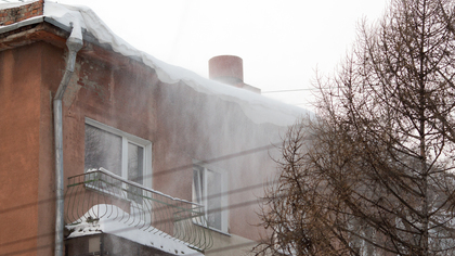 Новое обрушение снега с крыши здания в Ленинске-Кузнецком избавило балкон от сайдинга